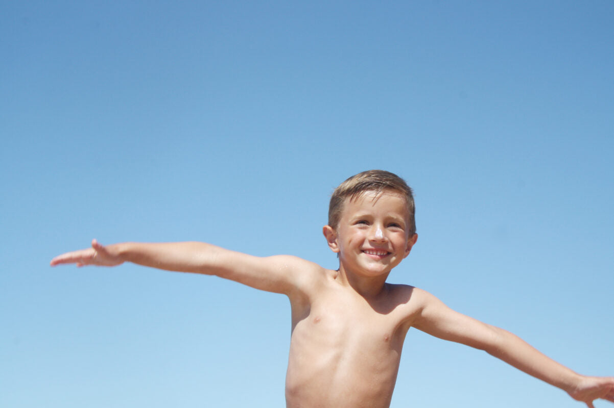 Happy child with sunscreen applied